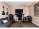 Well lit and spacious bonus room includes a sofa, desk, and an entertainment center at 1721 E Cielo Grande Ave, Phoenix, AZ 85024