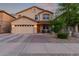 Charming two-story home featuring a well-manicured front yard, two car garage, and inviting front porch at 1721 E Cielo Grande Ave, Phoenix, AZ 85024