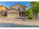 Charming two-story home featuring a well-manicured front yard, two car garage, and inviting front porch at 1721 E Cielo Grande Ave, Phoenix, AZ 85024