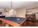 Entertaining game room with a pool table, wet bar, recessed lighting, and hardwood flooring at 1721 E Cielo Grande Ave, Phoenix, AZ 85024