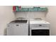 Laundry room featuring white washer and dryer with a storage shelf at 1721 E Cielo Grande Ave, Phoenix, AZ 85024
