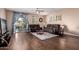 Inviting living room with hardwood floors, comfortable seating, and sliding glass doors to the patio at 1721 E Cielo Grande Ave, Phoenix, AZ 85024