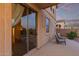 Covered patio with tile floor features comfortable seating and backyard access at 1721 E Cielo Grande Ave, Phoenix, AZ 85024