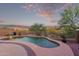Beautiful backyard pool area at dusk with desert landscaping at 1721 E Cielo Grande Ave, Phoenix, AZ 85024