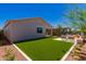 A private backyard offering ample green space with patio and a cozy seating area at 17650 W Bajada Rd, Surprise, AZ 85387