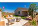 Beautiful backyard with outdoor seating, low maintenance artificial grass, and a covered patio at 17650 W Bajada Rd, Surprise, AZ 85387