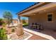 Inviting outdoor space featuring a covered patio, elegant water feature, and lush landscaping at 17650 W Bajada Rd, Surprise, AZ 85387