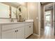 Bright bathroom with dual sinks, white cabinetry, quartz countertops, and modern fixtures at 17650 W Bajada Rd, Surprise, AZ 85387