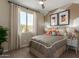 Tastefully decorated bedroom with a large window, side tables, and a contemporary design at 17650 W Bajada Rd, Surprise, AZ 85387