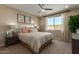 Bright bedroom featuring a neutral color palette, king-size bed, ceiling fan, and natural light at 17650 W Bajada Rd, Surprise, AZ 85387