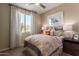 Inviting bedroom with a comfortable bed, large window, and stylish decor elements at 17650 W Bajada Rd, Surprise, AZ 85387
