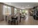 Elegant dining area with stylish table setting, modern lighting, and views of the outdoor patio at 17650 W Bajada Rd, Surprise, AZ 85387