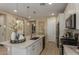 Bright kitchen featuring a spacious island with quartz countertops and modern pendant lighting at 17650 W Bajada Rd, Surprise, AZ 85387