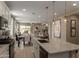 Open kitchen showcasing a large island, modern appliances, and seamless transition to dining area at 17650 W Bajada Rd, Surprise, AZ 85387