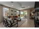 Inviting living room featuring comfortable seating, abundant windows, and access to outdoor patio at 17650 W Bajada Rd, Surprise, AZ 85387