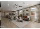 Bright living room showcasing modern furnishings, neutral tones, and seamless flow to dining area at 17650 W Bajada Rd, Surprise, AZ 85387
