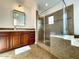Luxurious bathroom with walk-in shower, custom tile work, vanity with double sinks, and elegant fixtures at 18507 N 94Th St, Scottsdale, AZ 85255