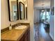 Bathroom featuring tile flooring, wood cabinets, modern mirrors and great light at 18507 N 94Th St, Scottsdale, AZ 85255
