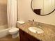 Bathroom features a granite countertop, decorative lighting, and tiled shower/tub at 18507 N 94Th St, Scottsdale, AZ 85255