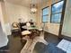 Elegant dining room with modern chandelier, wood floors and an animal print rug at 18507 N 94Th St, Scottsdale, AZ 85255