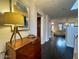 Inviting entryway with dark wood floors, wood cabinet and modern art at 18507 N 94Th St, Scottsdale, AZ 85255