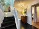 Stairway to the entry with a modern lamp, artwork, and an open doorway into the Primary bedroom at 18507 N 94Th St, Scottsdale, AZ 85255