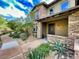 Beautiful two-story stone home with desert landscaping and a covered entryway at 18507 N 94Th St, Scottsdale, AZ 85255