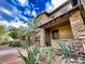 Inviting stone-accented home exterior with well-manicured landscaping and a covered front entrance at 18507 N 94Th St, Scottsdale, AZ 85255