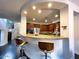 Modern kitchen bar area with wooden cabinets and granite countertops at 18507 N 94Th St, Scottsdale, AZ 85255
