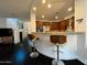 Gourmet kitchen featuring granite countertops, wooden cabinetry, stainless steel appliances and breakfast bar at 18507 N 94Th St, Scottsdale, AZ 85255