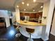 Modern kitchen featuring a breakfast bar with seating, granite countertops, and stainless steel appliances at 18507 N 94Th St, Scottsdale, AZ 85255