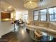 Spacious living room with wood floors, a stylish light fixture, and large windows at 18507 N 94Th St, Scottsdale, AZ 85255