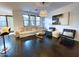 Bright living room with a comfortable sectional sofa, decorative lighting, and dark hardwood flooring at 18507 N 94Th St, Scottsdale, AZ 85255