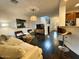 Open living area with dark hardwood floors, stylish furnishings, and natural light from adjacent rooms at 18507 N 94Th St, Scottsdale, AZ 85255