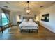 Bright primary bedroom with hardwood floors, white linens, decorative lighting, and neutral wall colors at 18507 N 94Th St, Scottsdale, AZ 85255
