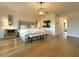 Spacious main bedroom with hardwood floors, a king bed, stylish decor, and a light fixture at 18507 N 94Th St, Scottsdale, AZ 85255