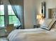 Bedroom with king bed, mirrored nightstand and desk by the window at 18507 N 94Th St, Scottsdale, AZ 85255