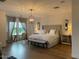 Spacious main bedroom featuring a king bed, bench, desk, and hardwood floors at 18507 N 94Th St, Scottsdale, AZ 85255