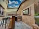 Outdoor kitchen featuring a built-in grill, counter space, and television for entertainment at 18507 N 94Th St, Scottsdale, AZ 85255