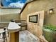Outdoor kitchen featuring a built-in grill, counter space, and television for entertainment at 18507 N 94Th St, Scottsdale, AZ 85255