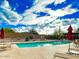Community pool with lounge chairs and desert landscaping on a sunny day at 18507 N 94Th St, Scottsdale, AZ 85255