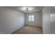 Cozy bedroom with neutral carpet, modern light fixture, and sun-filled window at 1916 W Morningside Dr # 111, Phoenix, AZ 85023