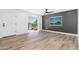 Bedroom features wood floors, a sliding glass door to a balcony, and a contemporary accent wall at 1916 W Morningside Dr # 111, Phoenix, AZ 85023