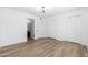 Bright bedroom featuring wood-look floors, modern lighting, and closet space at 1916 W Morningside Dr # 111, Phoenix, AZ 85023
