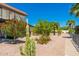 Community grounds filled with mature trees and a sidewalk path at 1916 W Morningside Dr # 111, Phoenix, AZ 85023