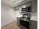 Gray cabinets, stainless steel appliances, and quartz countertops complete this modern kitchen at 1916 W Morningside Dr # 111, Phoenix, AZ 85023