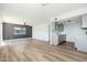 View of living room and kitchen featuring hardwood floors, gray cabinets, and gray accent wall at 1916 W Morningside Dr # 111, Phoenix, AZ 85023