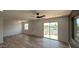 Bright living room featuring wood-look floors, ceiling fan, sliding door, and neutral paint scheme at 1916 W Morningside Dr # 111, Phoenix, AZ 85023