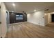 Spacious living room features wood floors, dark accent wall, and sliding glass doors at 1916 W Morningside Dr # 111, Phoenix, AZ 85023