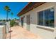 View of the condo patio featuring tile flooring, an security door, and a view of palms at 1916 W Morningside Dr # 111, Phoenix, AZ 85023